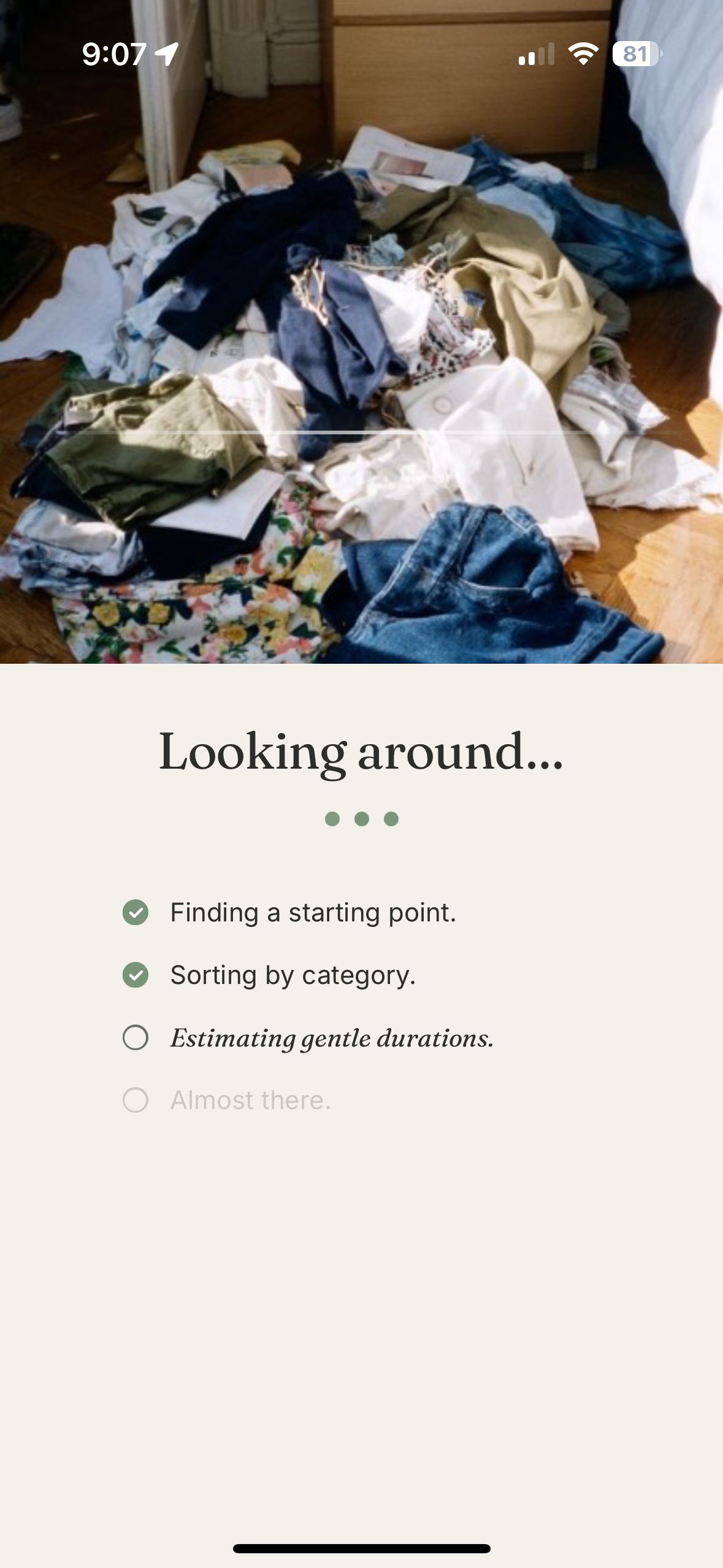 The TidyCalm analyzing screen above a photo of a bedroom floor covered in clothes, working through the room: a starting point found, categories sorted, gentle durations still being estimated.